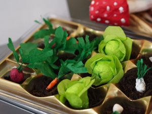 Petit potager créatif Happap, entièrement réalisé en papier recyclé, représentant divers légumes miniatures comme des carottes, radis et salades, idéal comme décoration écologique et originale.