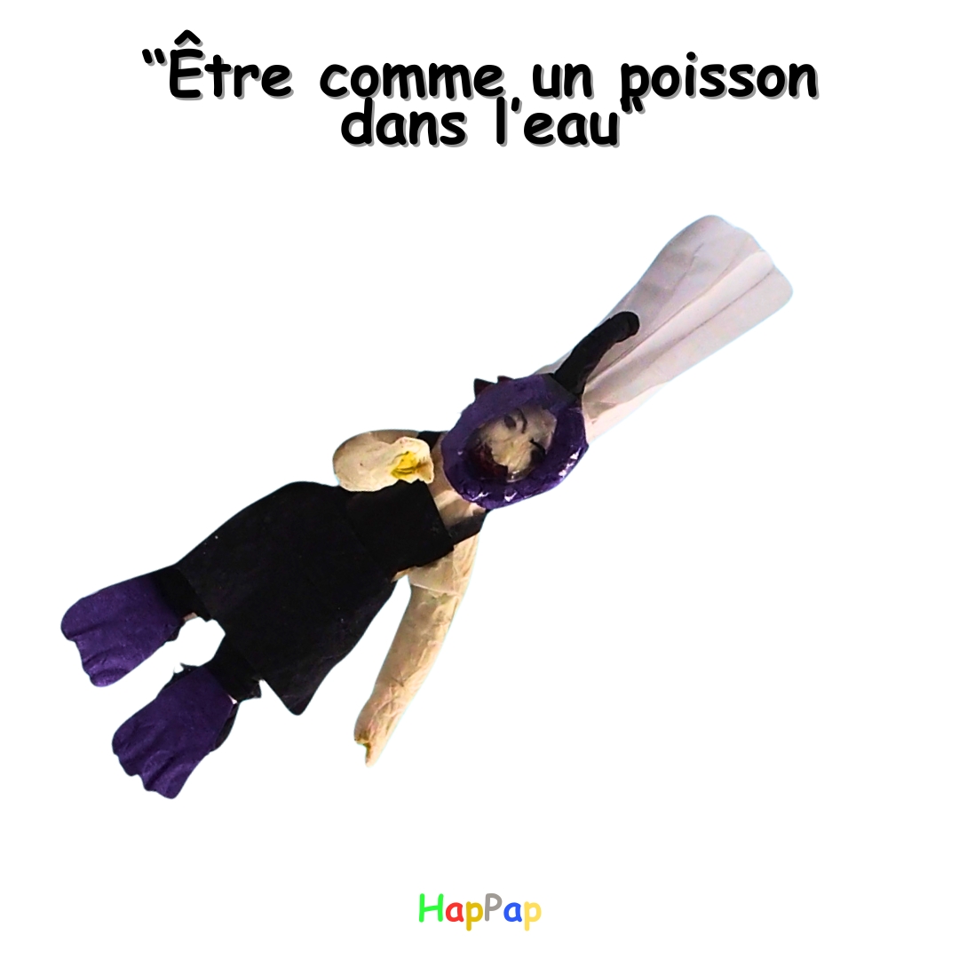 Illustration artistique en papier recyclé représentant l’expression « être comme un poisson dans l’eau », utilisée pour l’apprentissage du français de manière créative.