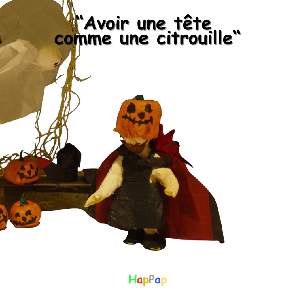 Personnage HapPap en papier de soie avec une tête en citrouille, illustrant l’expression française « avoir une tête comme une citrouille